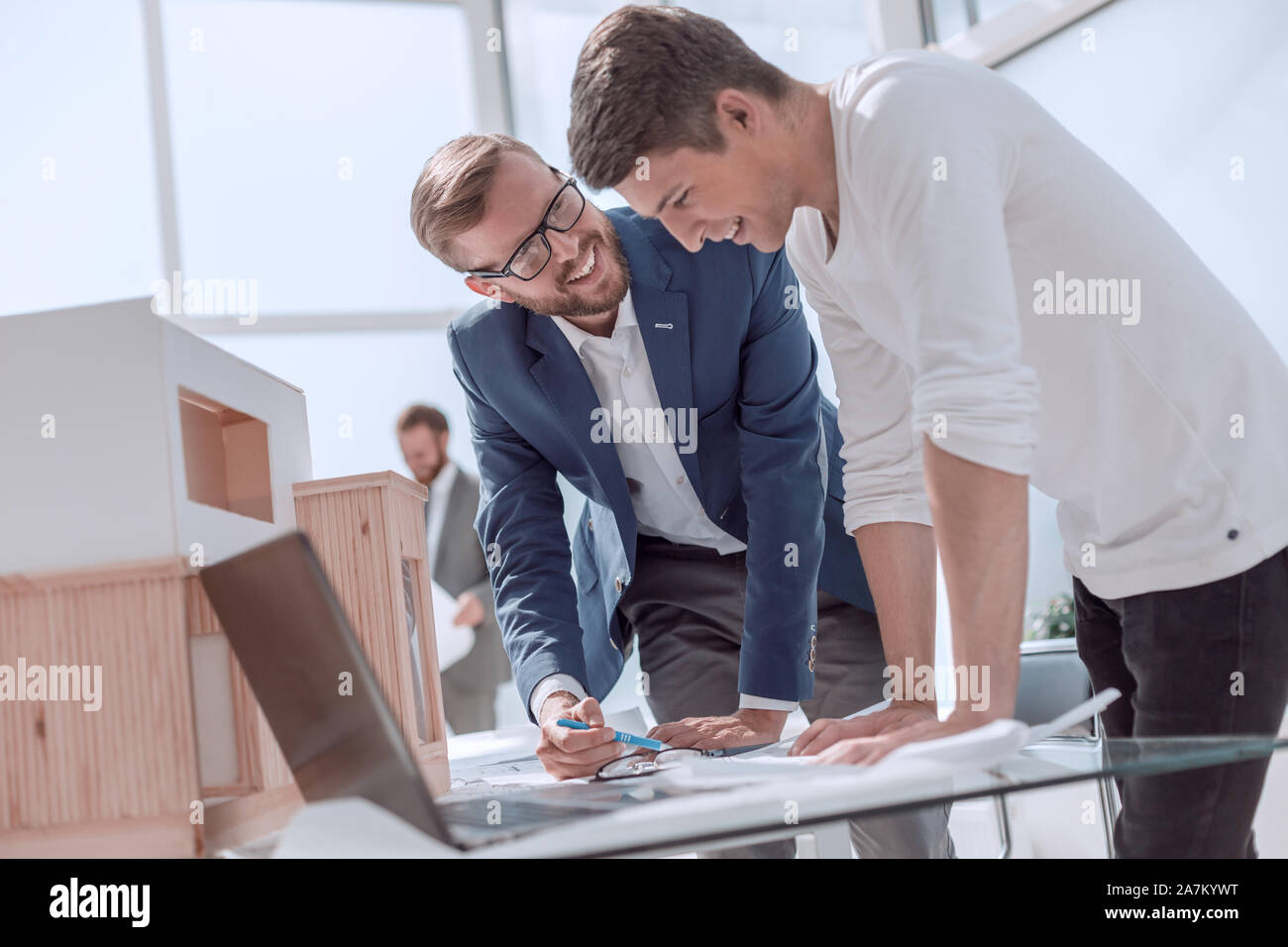smiling colleagues discussing a new architectural project Stock Photo