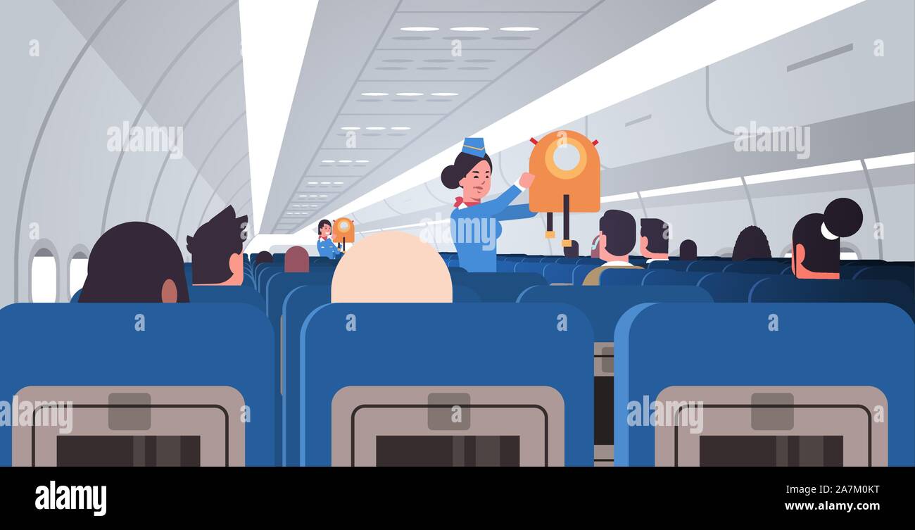 stewardess flight attendant explaining for passengers how to use jacket