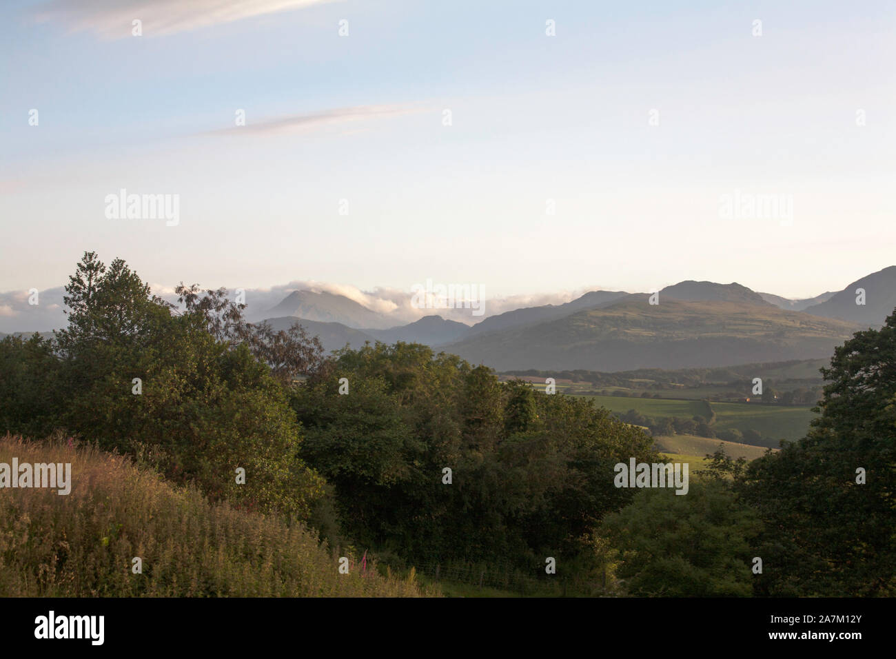 Morning mist surrounding  mountains along the Vale of Conwy Snowdonia on a summer morning near  the village of Eglwysbach Conwy North Wales Stock Photo