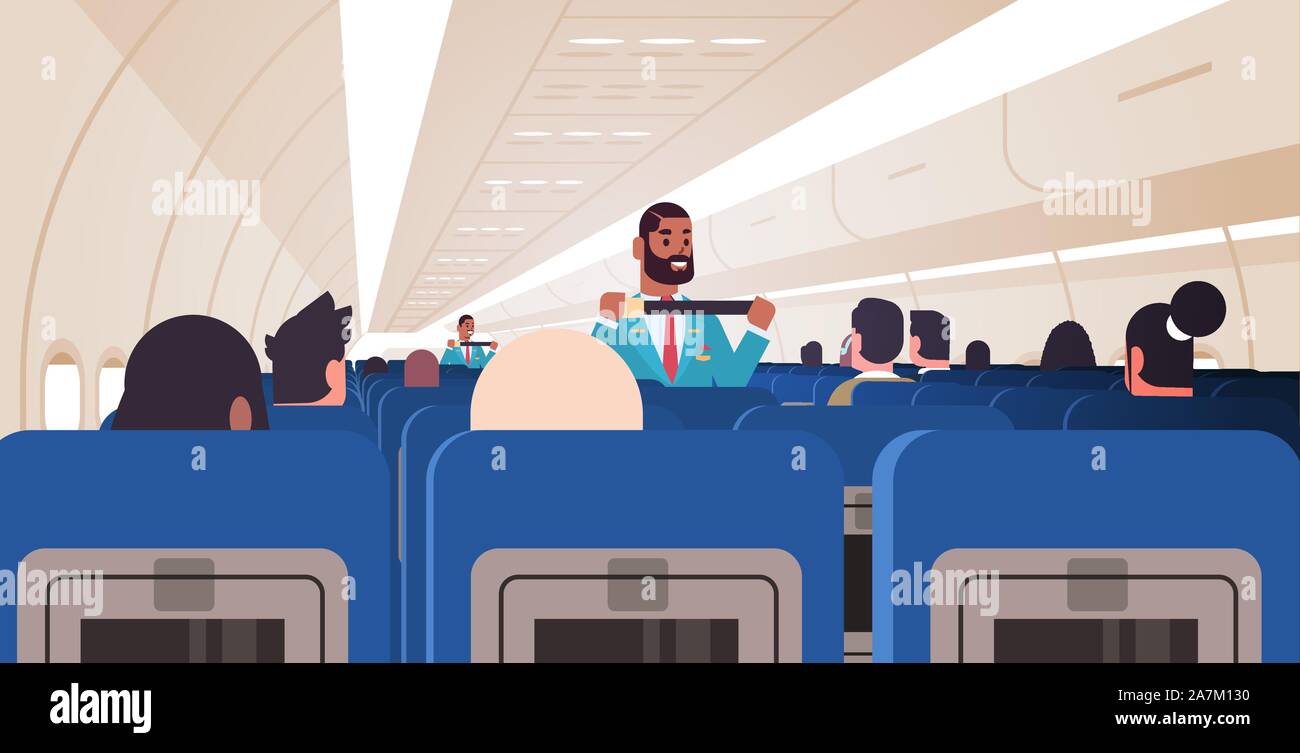 steward explaining passengers how to use seat belt fastening in