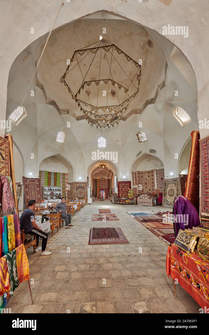 carpets inside Tim-Abdullakhan Bazaar, Ancient Trading Dome in Bukhara, Uzbekistan, Central Asia Stock Photo