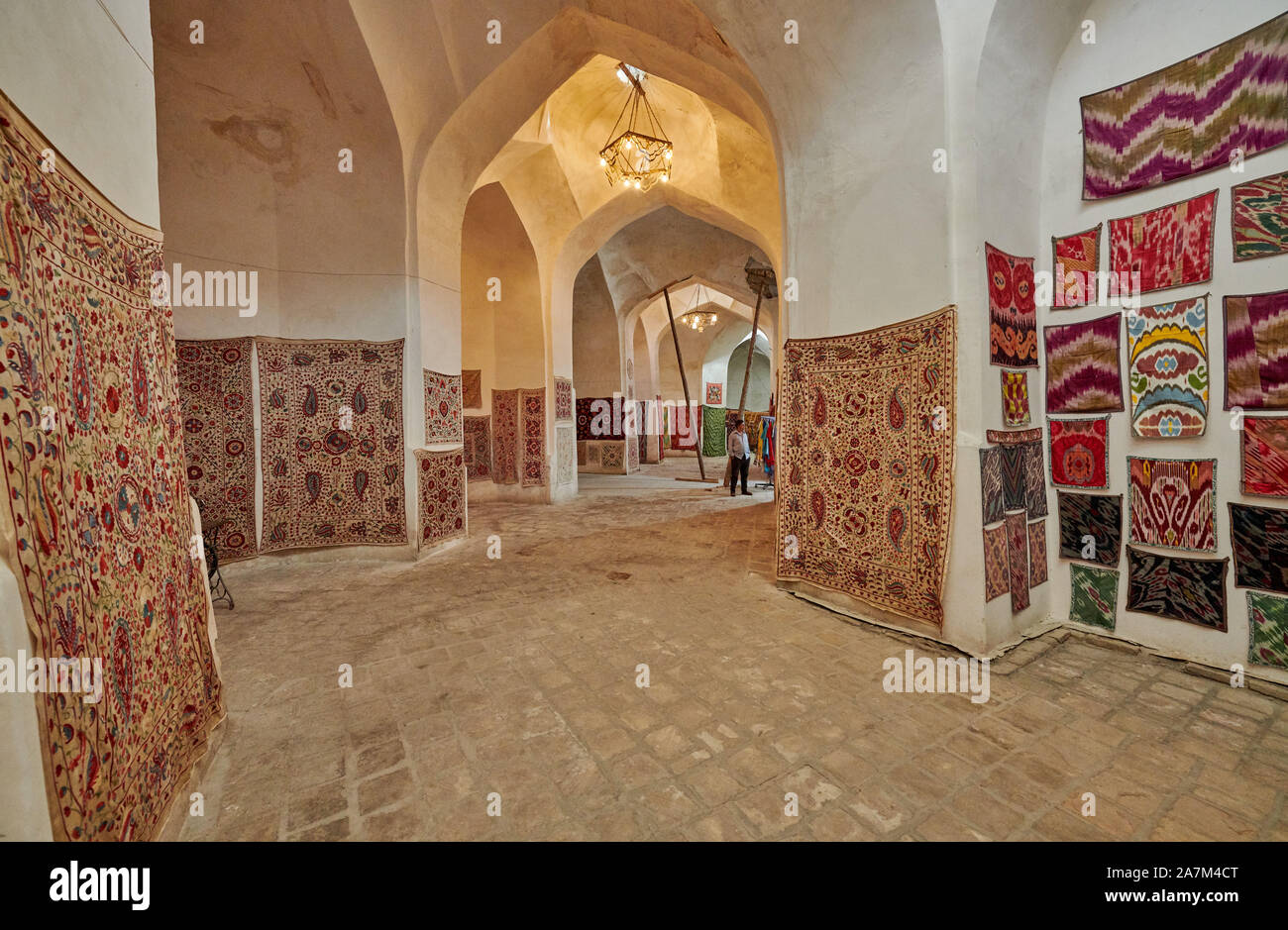carpets inside Tim-Abdullakhan Bazaar, Ancient Trading Dome in Bukhara, Uzbekistan, Central Asia Stock Photo