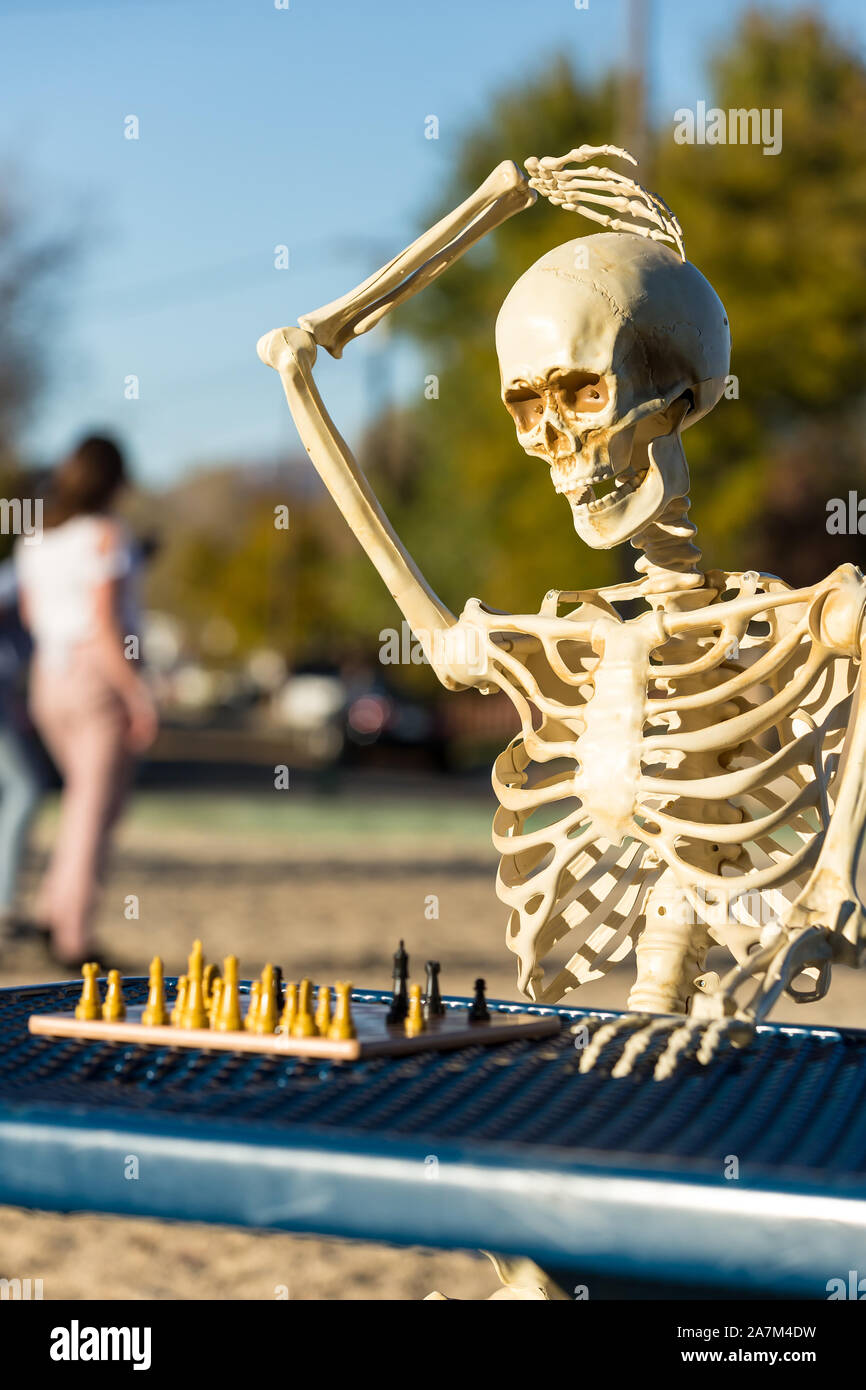 Skeleton scratches head trying to figure out next chess move Stock Photo -  Alamy
