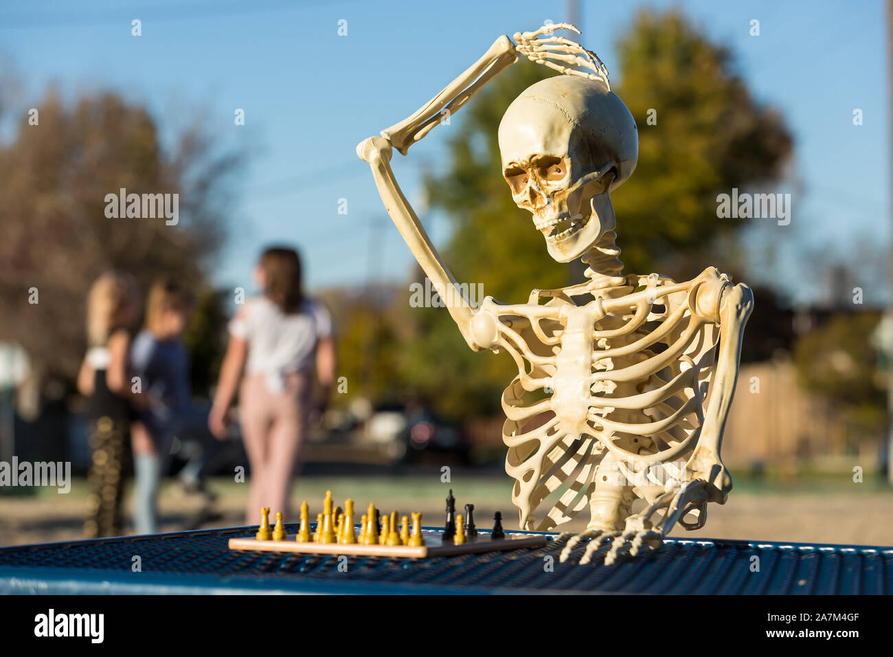 Skeleton scratches head trying to figure out next chess move Stock Photo -  Alamy