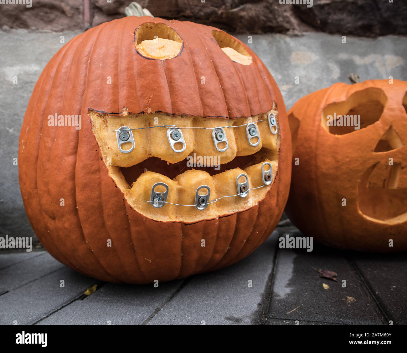 Halloween monster is carved out in a pumpkin..with tooth braces.. Stock Photo