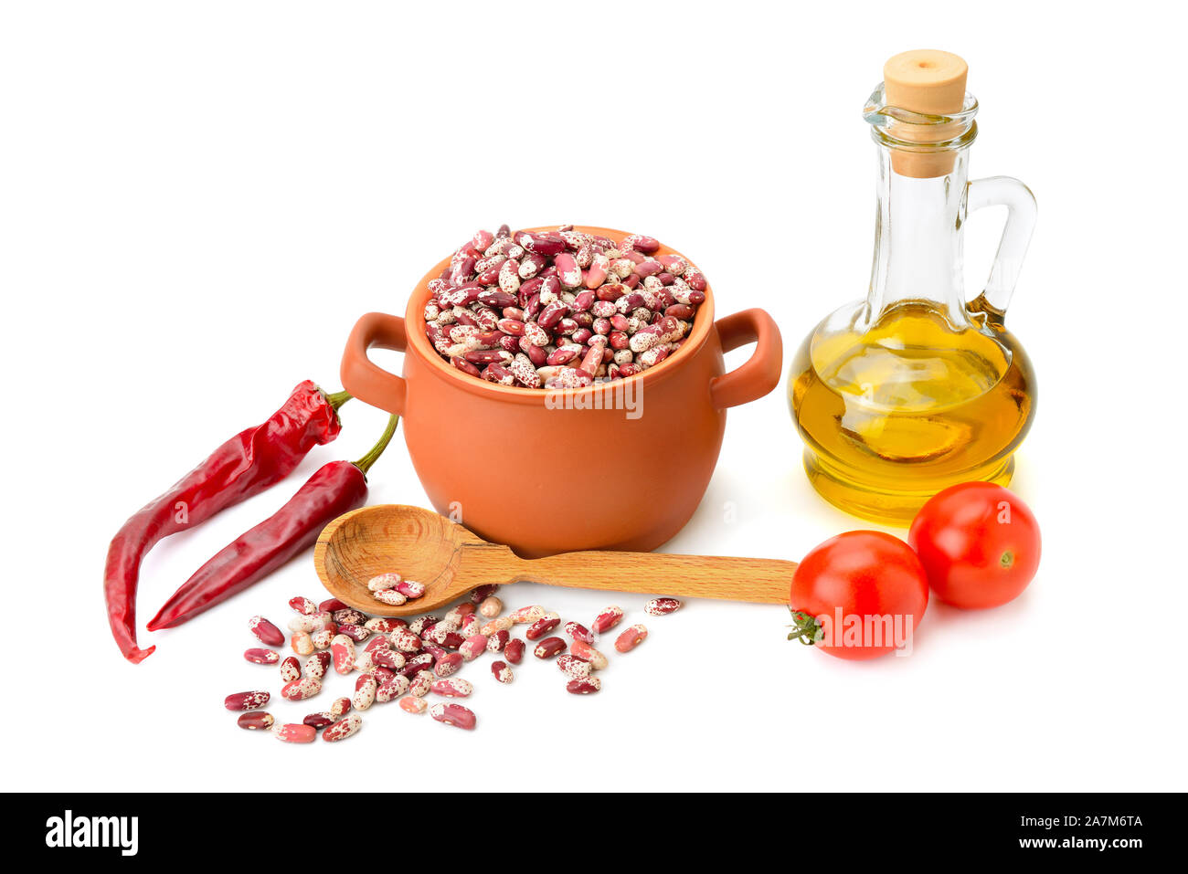 beans in a ceramic pot, cooking oil and vegetables isolated on white