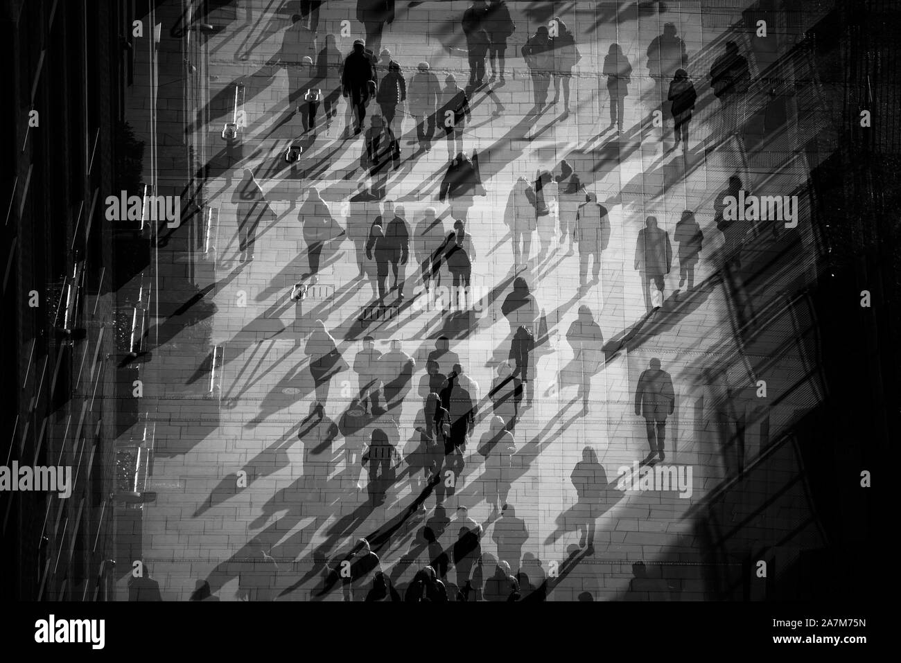 The busy streets of London, emphasised by an in-camera triple exposure, in black and white. Stock Photo