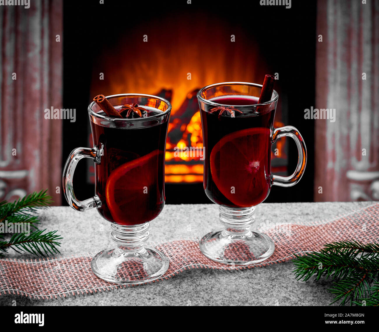 Two mulled wine glasses by the fireplace, christmas time Stock Photo