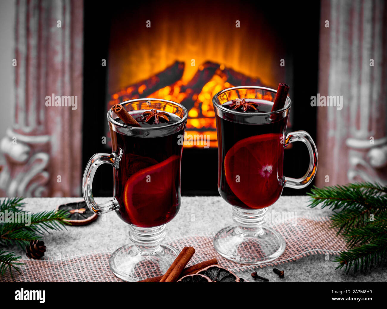 Two mulled wine glasses by the fireplace, christmas time Stock Photo