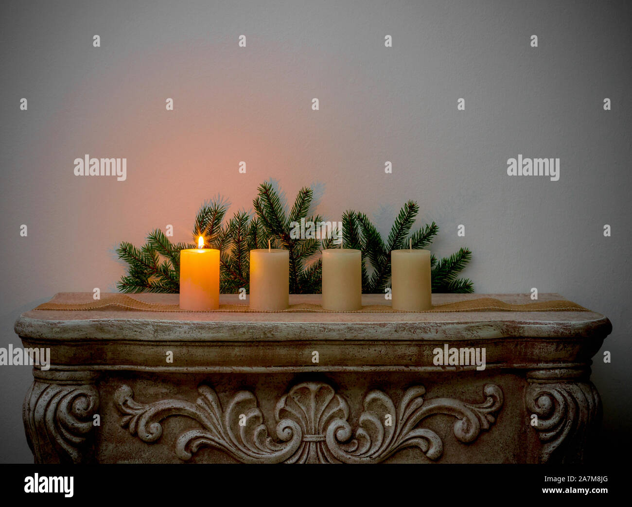 Four Advent candles on fireplace, first Advent Stock Photo
