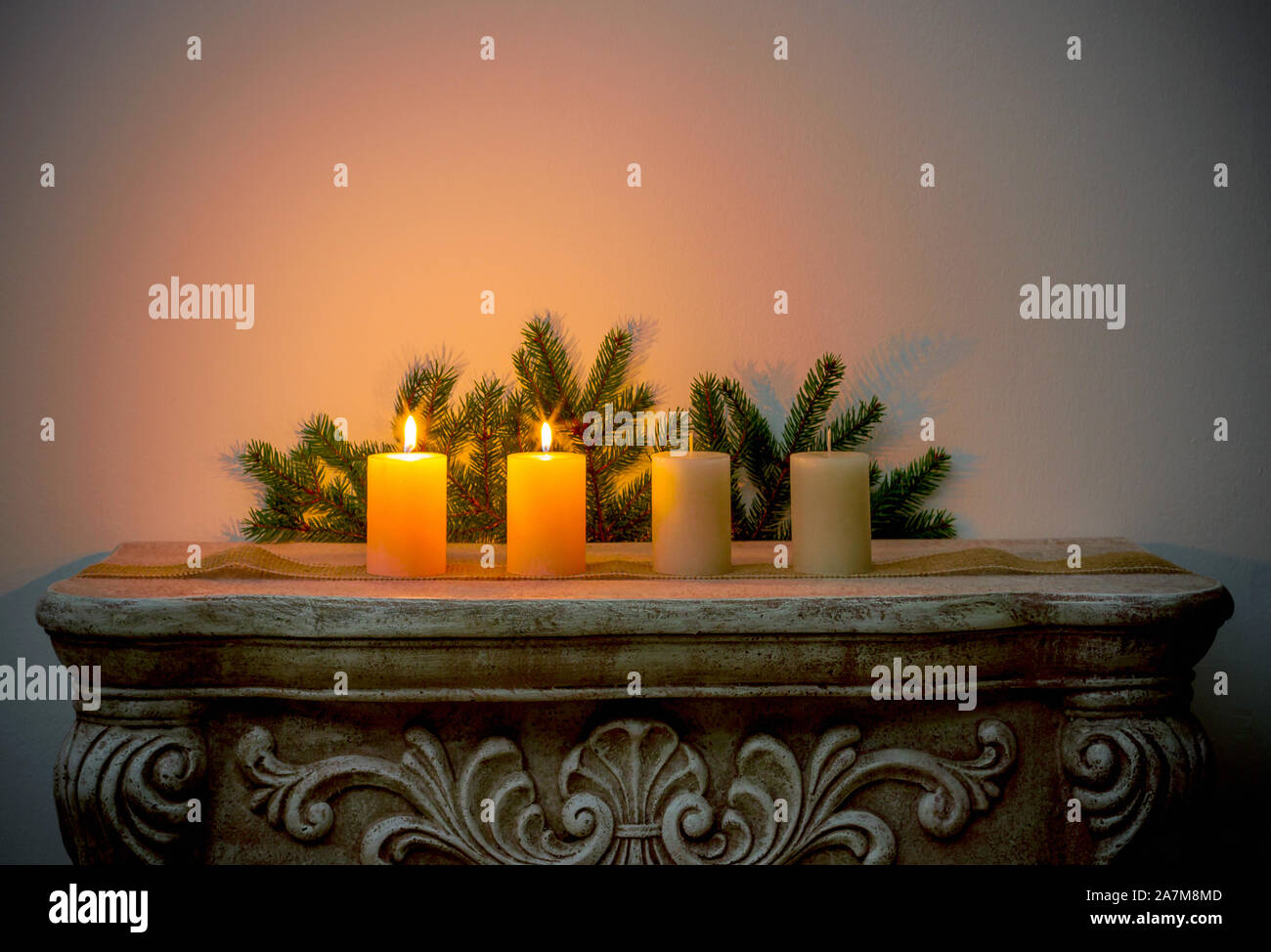 Four Advent candles on fireplace, second Advent Stock Photo