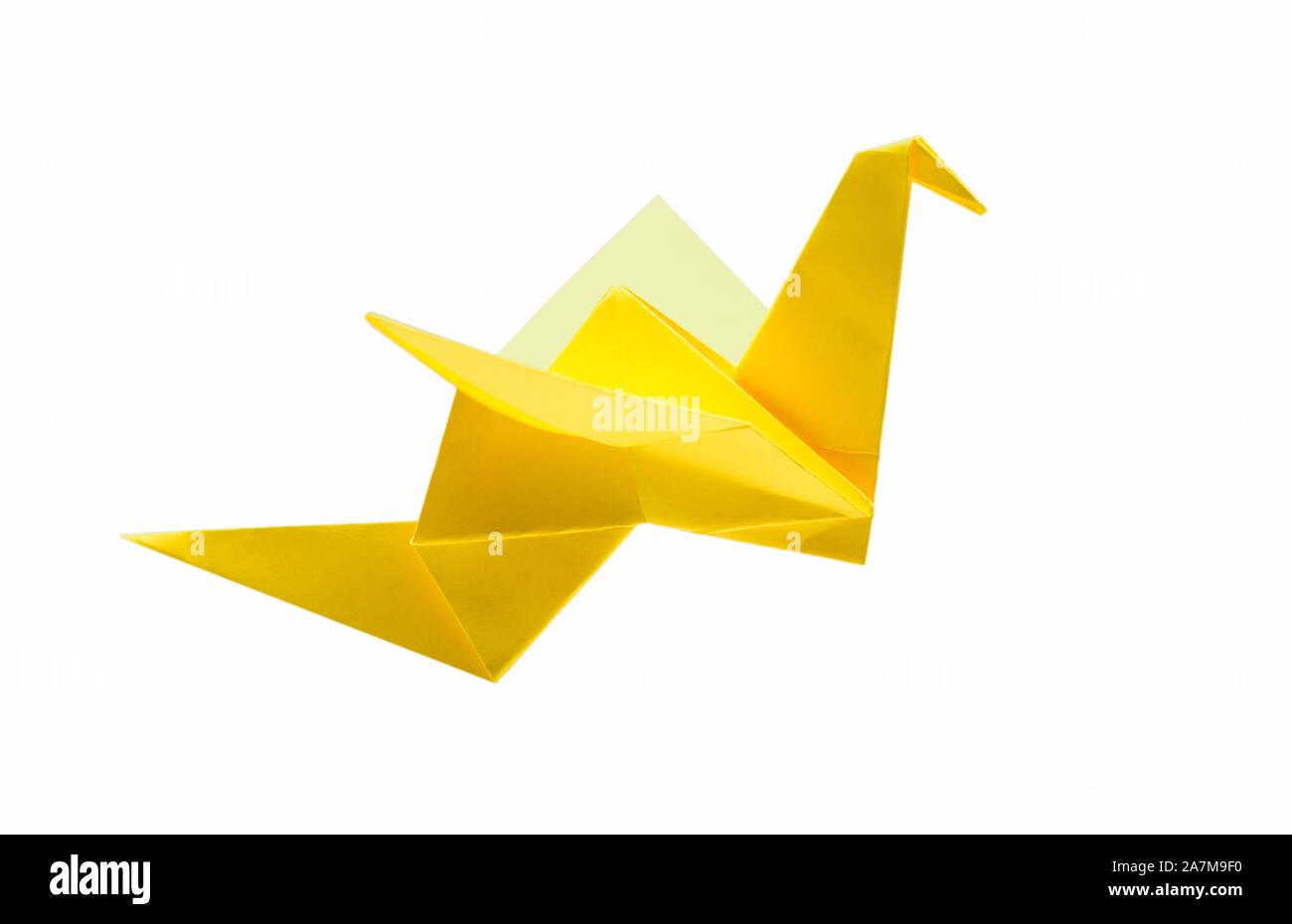 Origami flying bird isolated with clipping path. Japanese folded paper swan. Side view Stock Photo