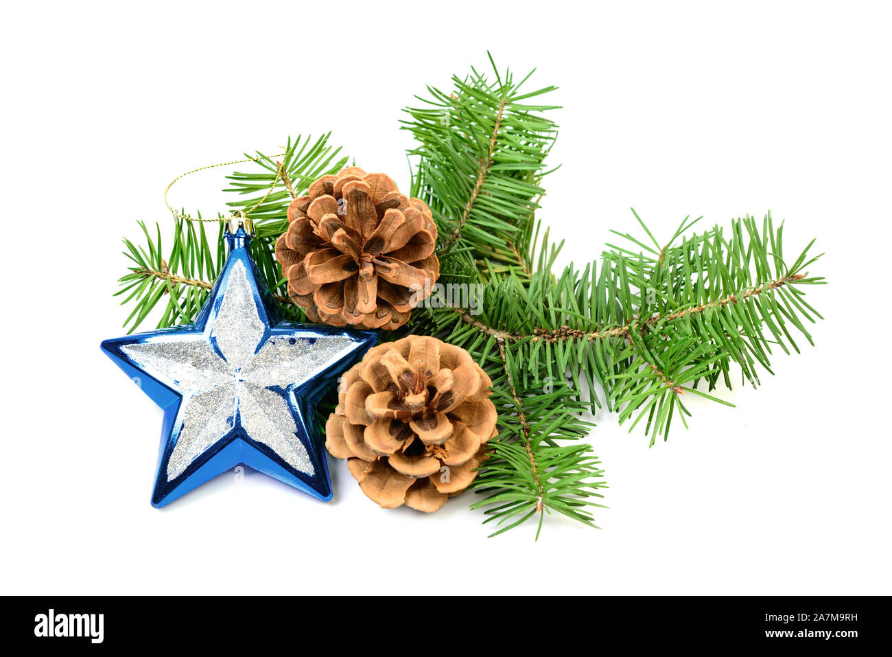 Pine cones with spruce tree branch and Christmas decoration on a white background Stock Photo