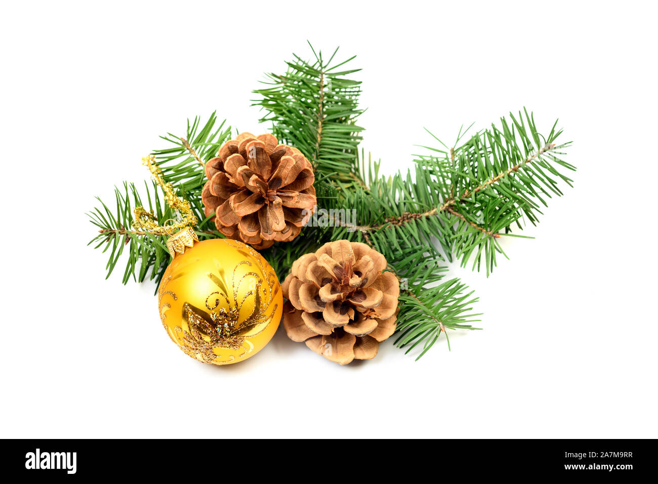 Pine cones with spruce tree branch and Christmas decoration ball on a white background Stock Photo
