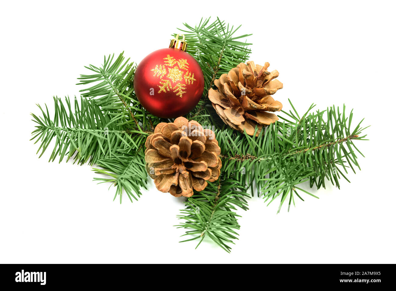 Pine cones with spruce tree branch and Christmas decoration ball on a white background Stock Photo