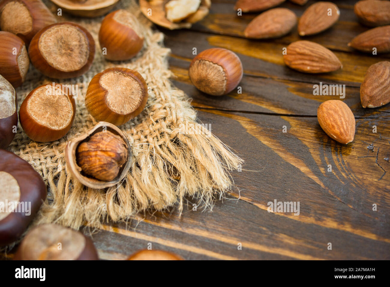 Mix of different nuts on a rustic background. Close-up photo with copy space. Healthy nutrition concept. Stock Photo