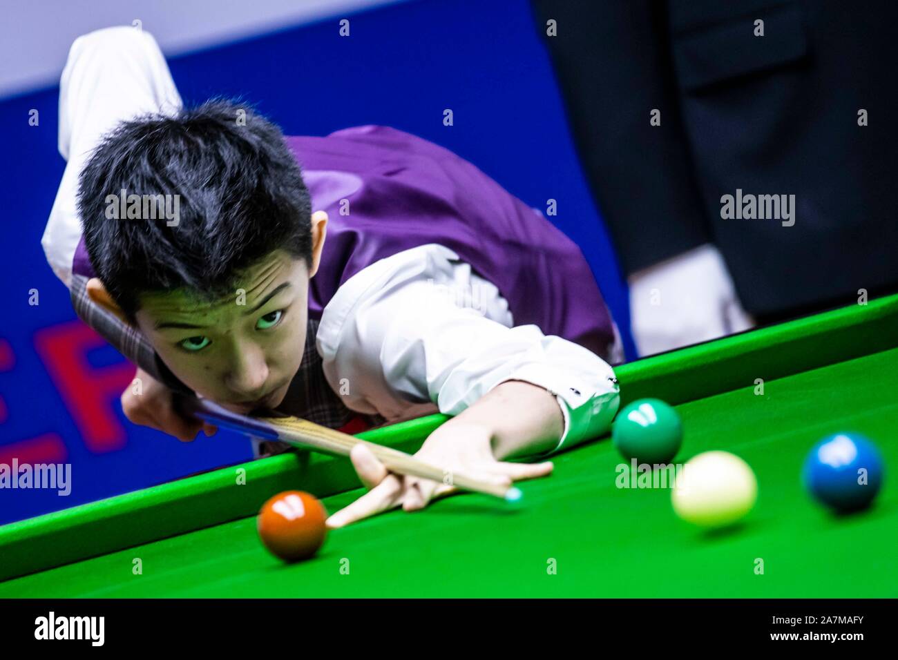 Chinese professional snooker player Wu Yize plays a shot at the Round 1 ...
