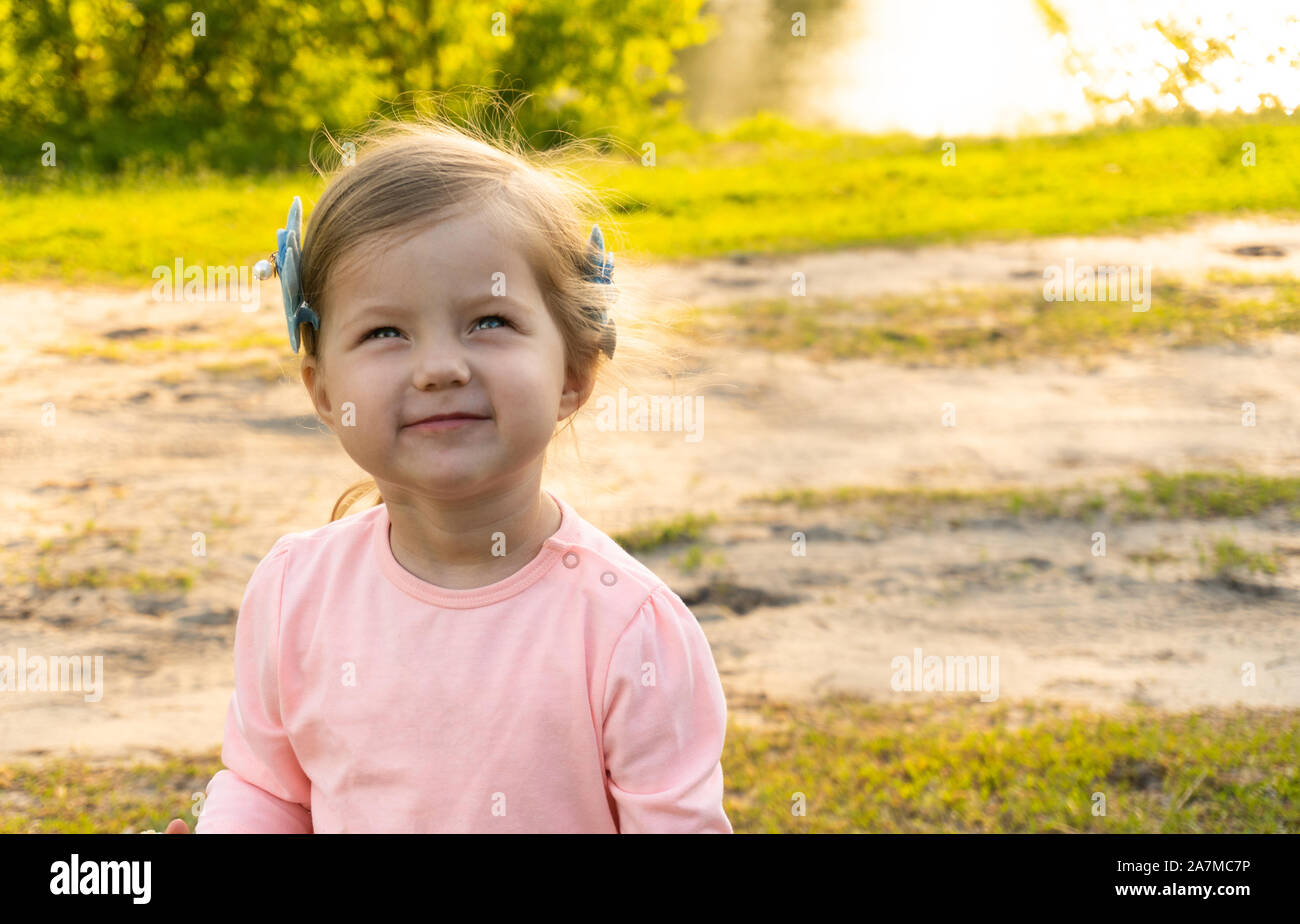 Funny face of little kid girl outdoor Stock Photo