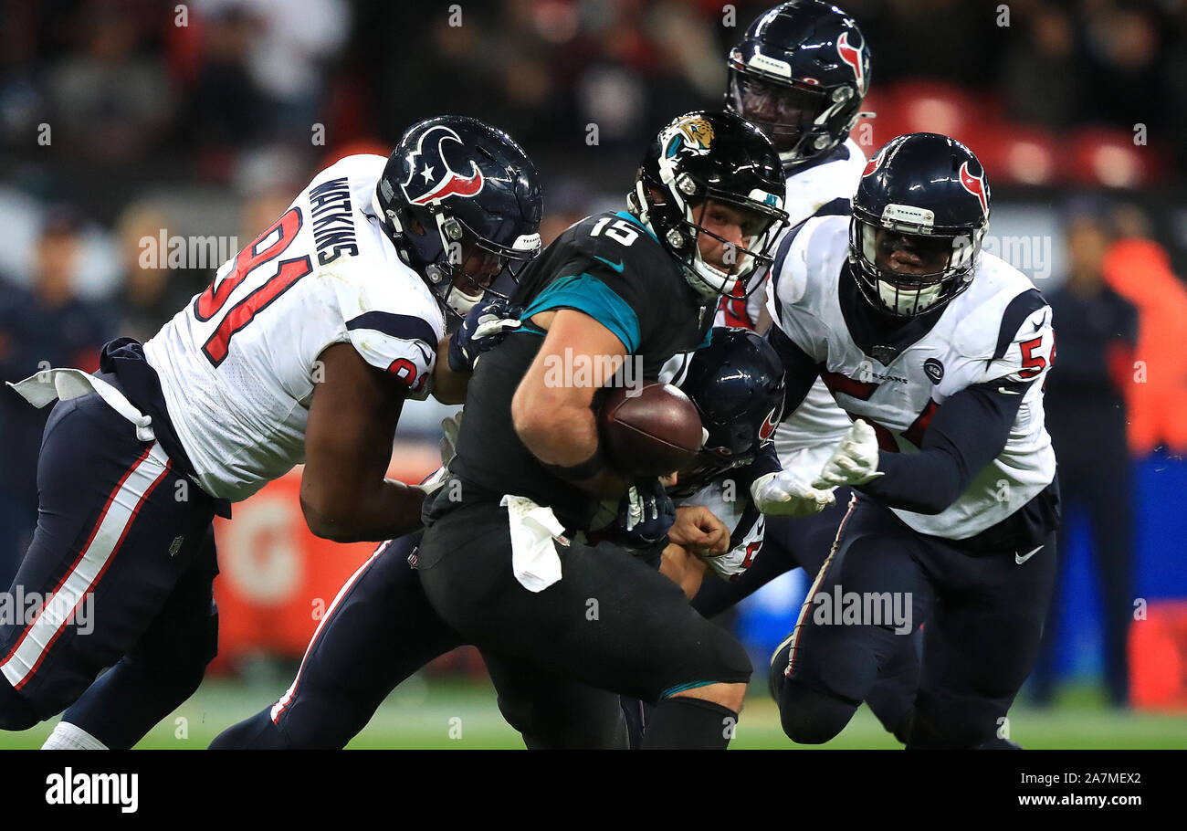Jacksonville Jaguars' Gardner Minshew II (centre) fumbles the ball