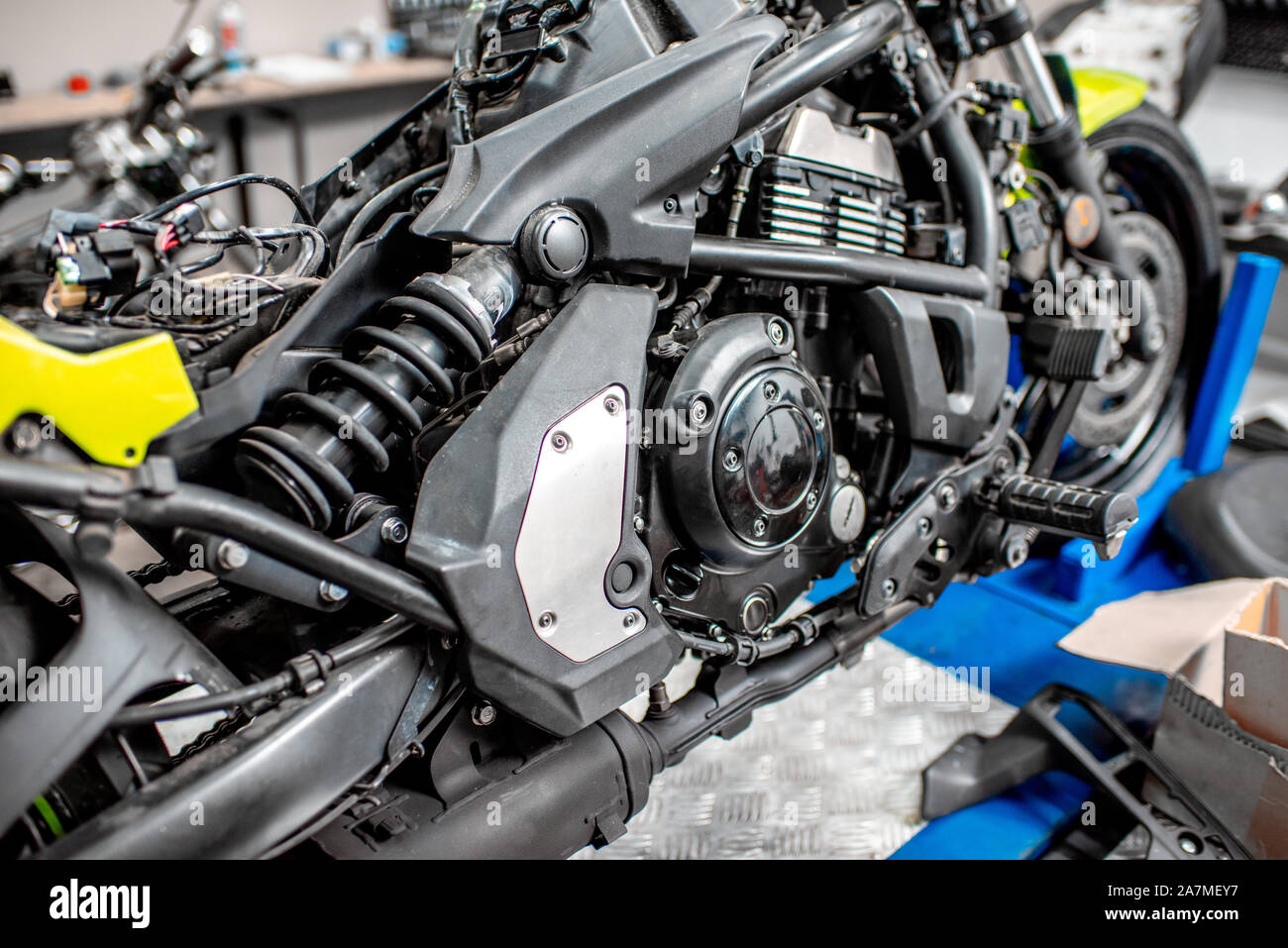 Close-up of a sports motorcycle standing on a lift during the maintenance at the workshop Stock Photo