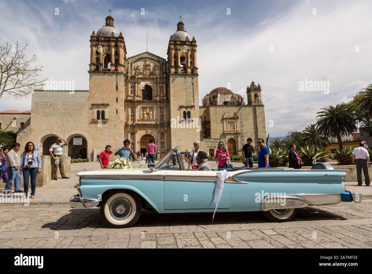 A classic Ford Galaxie Skyliner convertible car parked outside the Santo Domingo de Guzmán Church for a wedding in Oaxaca, Mexico. Stock Photo