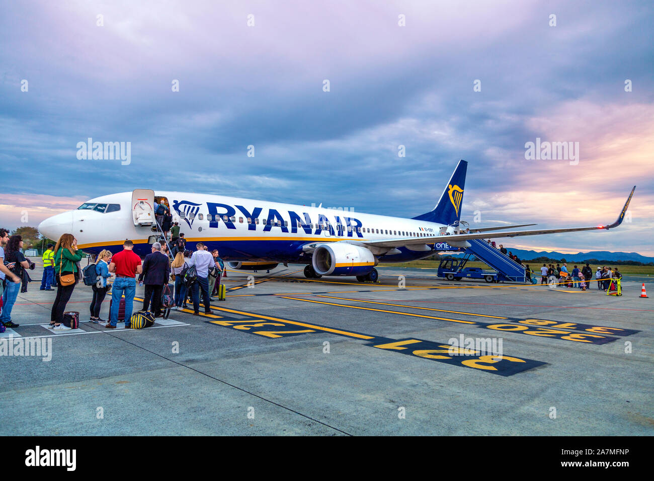 People boarding a Ryanair airplane on the tarmac at the Biarritz Airport, France Stock Photo