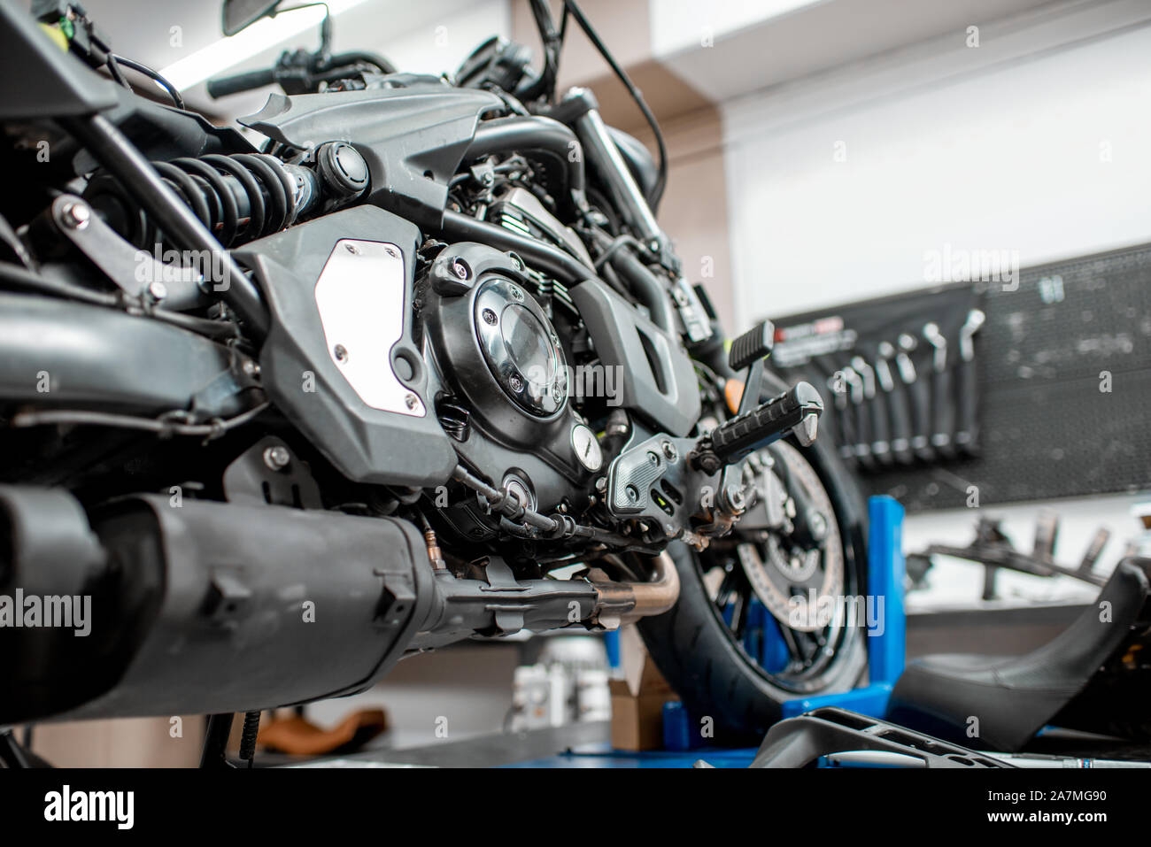 Close-up of a sports motorcycle standing on a lift during the maintenance at the workshop Stock Photo