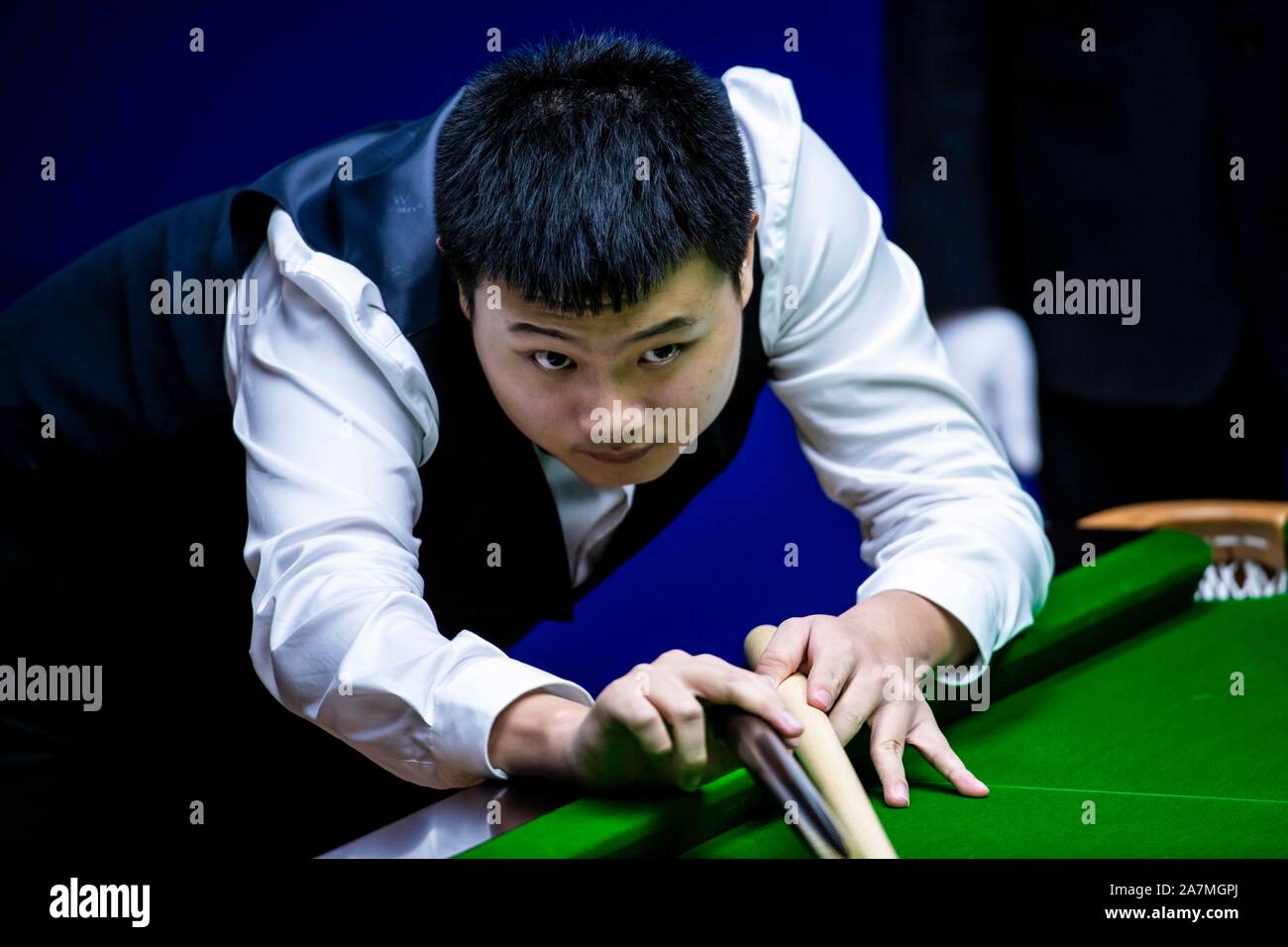 Chinese snooker player Huang Jianbo plays a shot at the Frist Round of ...