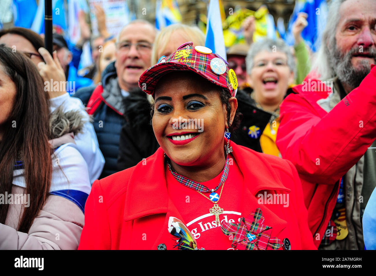 Glasgow, UK. 02nd Nov, 2019. An independence supporter smiles at photographers while wearing badges for Scottish Independence during the IndyRef2020 rally hosted by The National Newspaper. Credit: SOPA Images Limited/Alamy Live News Stock Photo
