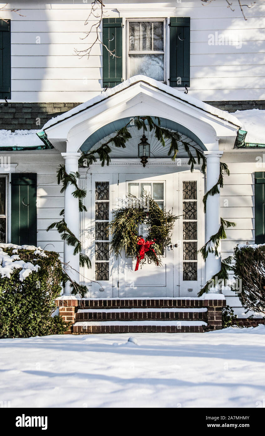 House white winter front door PT with a Christmas wreath, Cranbury, New Jersey, USA, US, house snow storm vintage Christmas house Victorian, America Stock Photo
