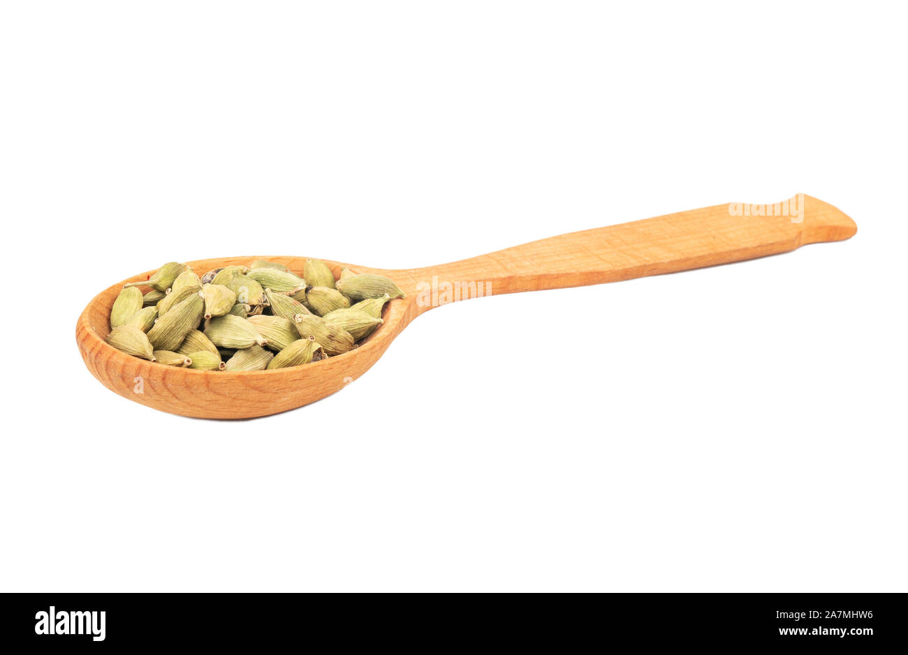 Dry cardamom in a large wooden spoon on a white background Stock Photo