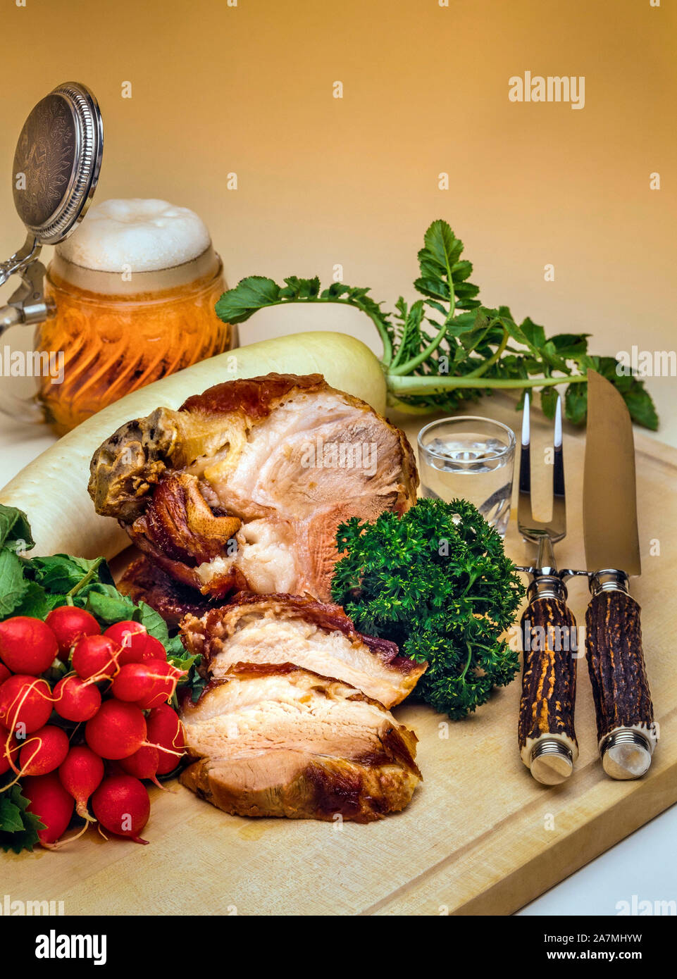 Roasted pork hock garnished with radish, Upper Bavaria, Bavaria, Germany, Europe Stock Photo