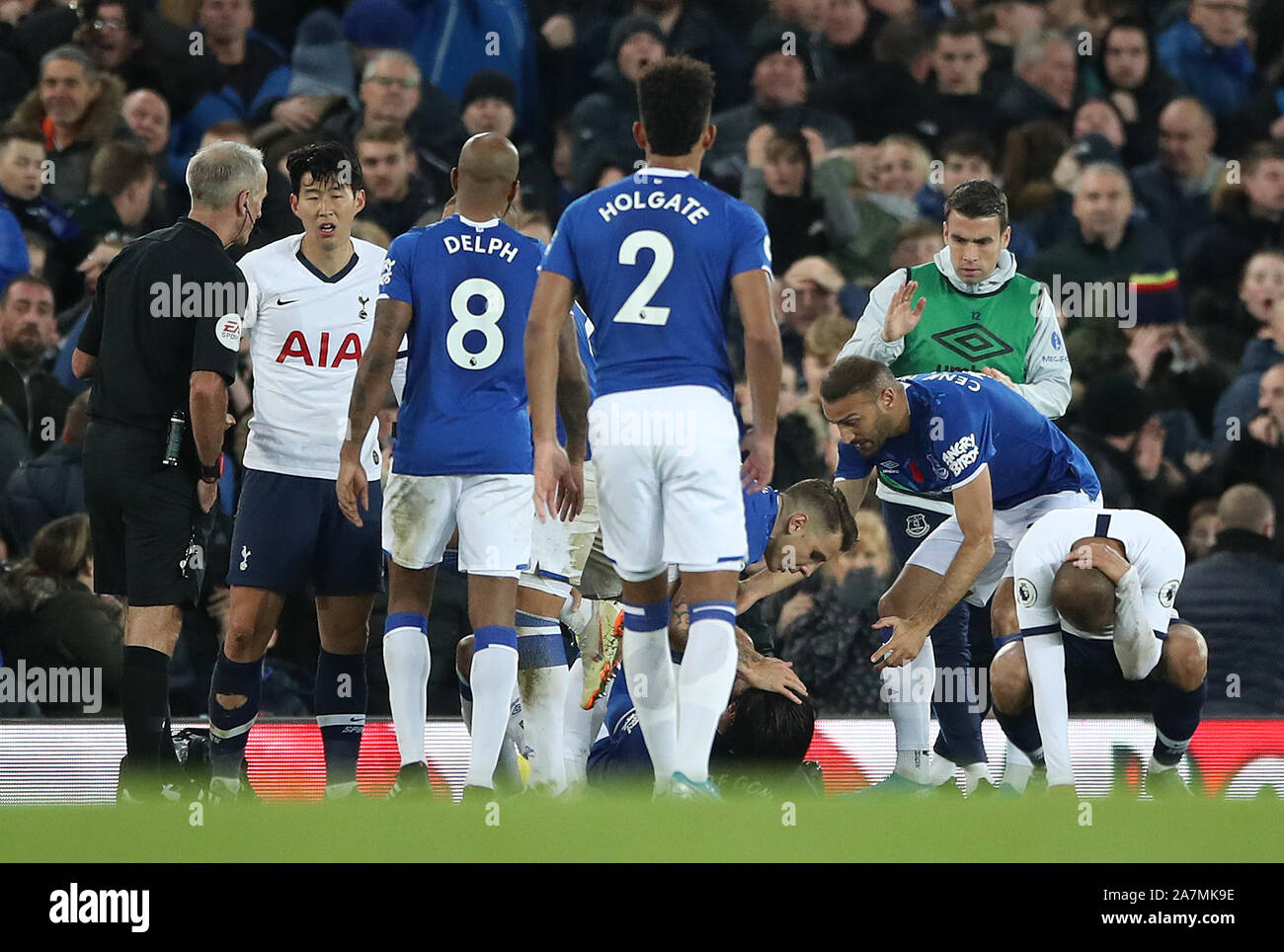 Everton check on the condition of team-mate Andre Gomes after a challenge during the Premier League match at Goodison Park, Liverpool. Stock Photo