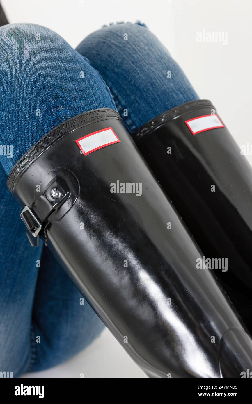 women's black rubber boots with blue jeans Stock Photo Alamy