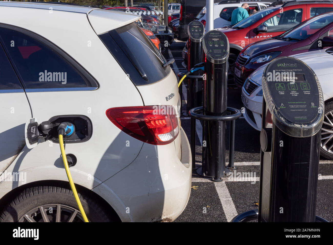 Electric car charging at PodPoint destination charger. Stock Photo