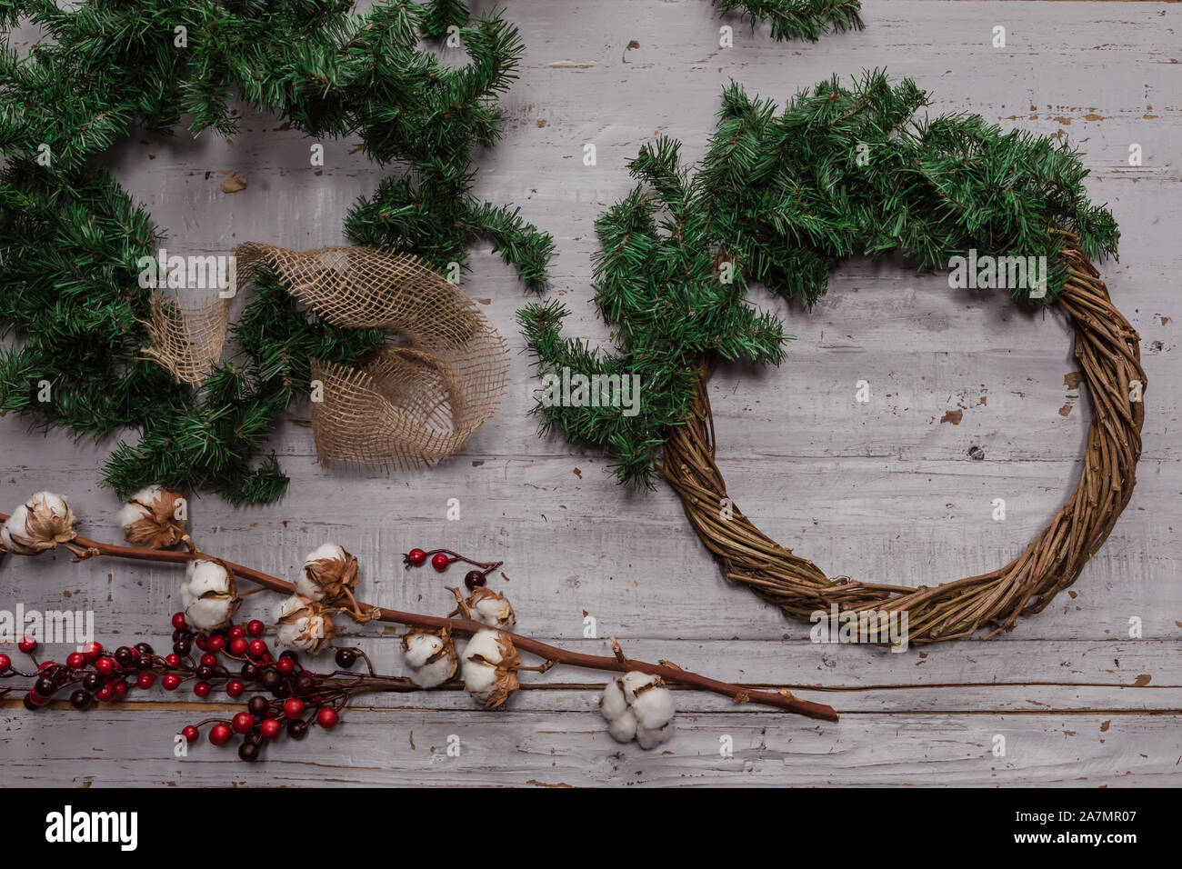 Top view of stages of making Christmas wreath with fir branches and ...