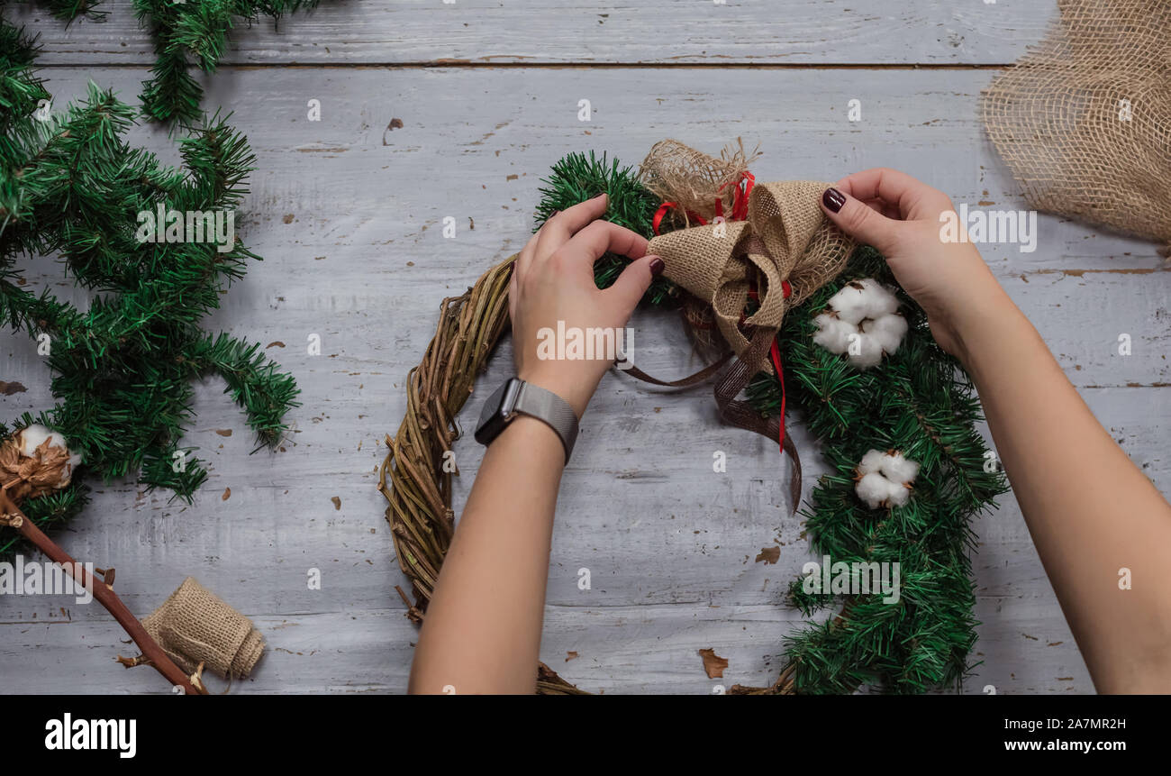 Top view of stages of making Christmas wreath with fir branches and ...