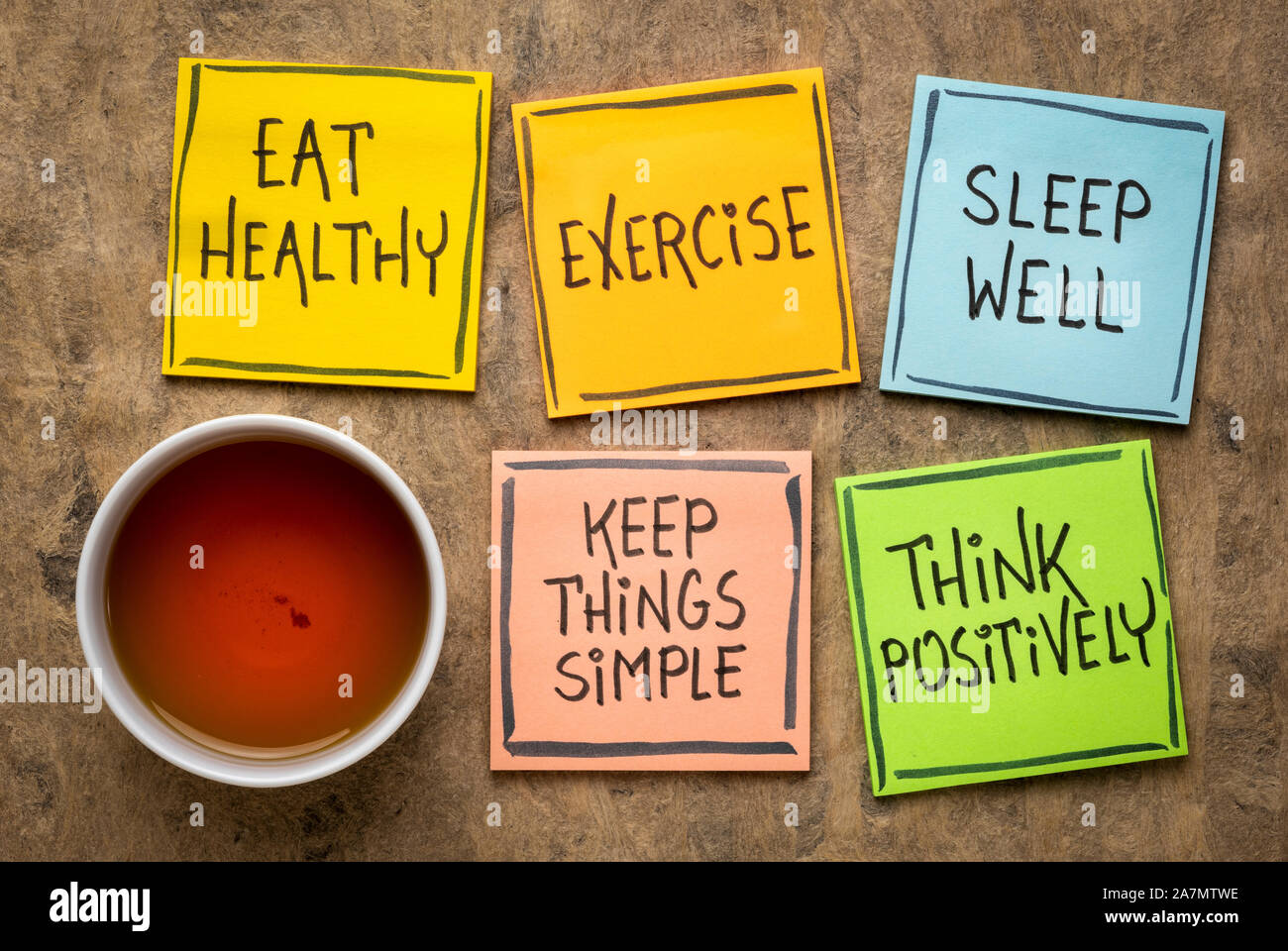 healthy lifestyle and wellbeing concept a set of inspirational reminder notes with a cup of