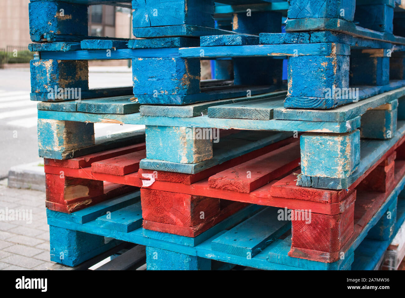 Wooden Pallets In Color Blue Light Red Closeup on a streed slighty used and  torn Stock Photo - Alamy