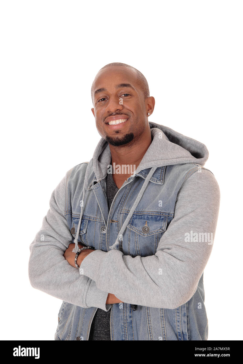 A closeup image of a young African American man standing in a jeans jacket with his arms crossed, isolated for white background Stock Photo