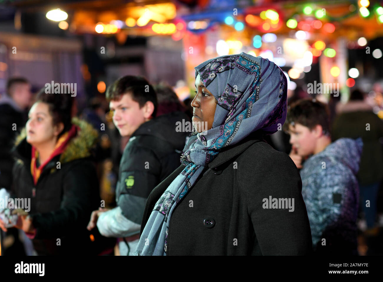 A mother watching her child on fairground ride Britain Uk Stock Photo