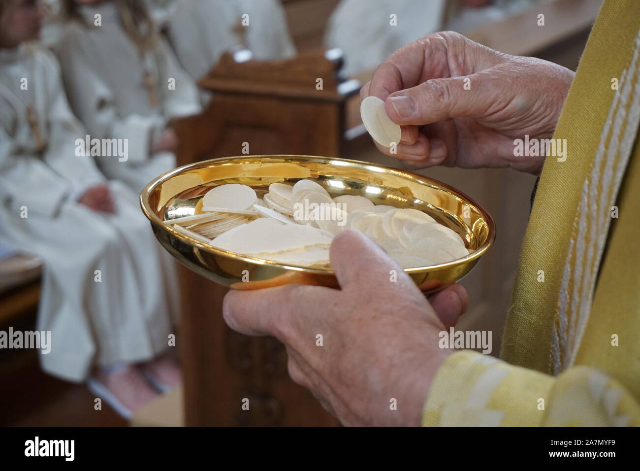 Altar Boy, Acolyte hold chalice with waver Stock Photo