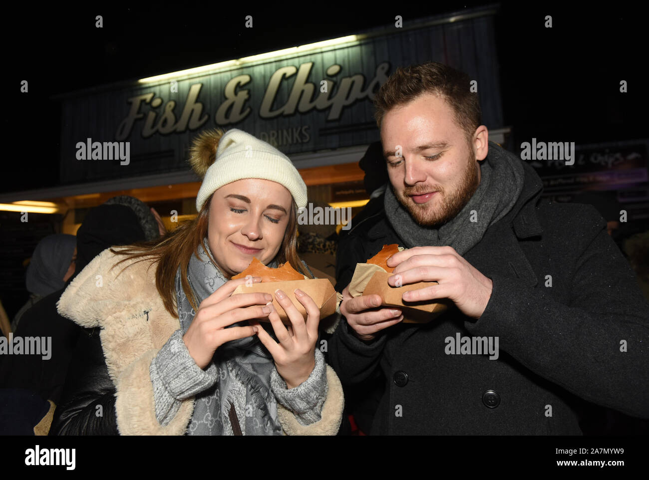 A couple eating take away food at night. Stock Photo