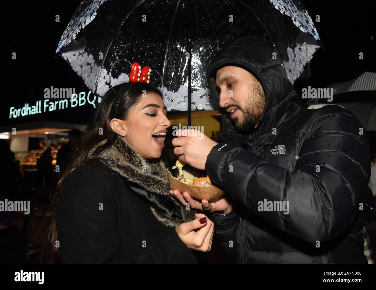 A couple eating take away food at night. Stock Photo