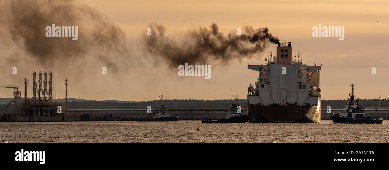 LNG tanker maneuvering in an offshore gas terminal. Stock Photo
