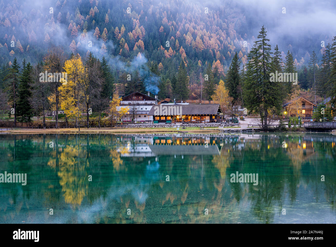Foggy evening at Lake Dobbiaco, Province of Bolzano, Trentino Alto Adige, Italy. Stock Photo