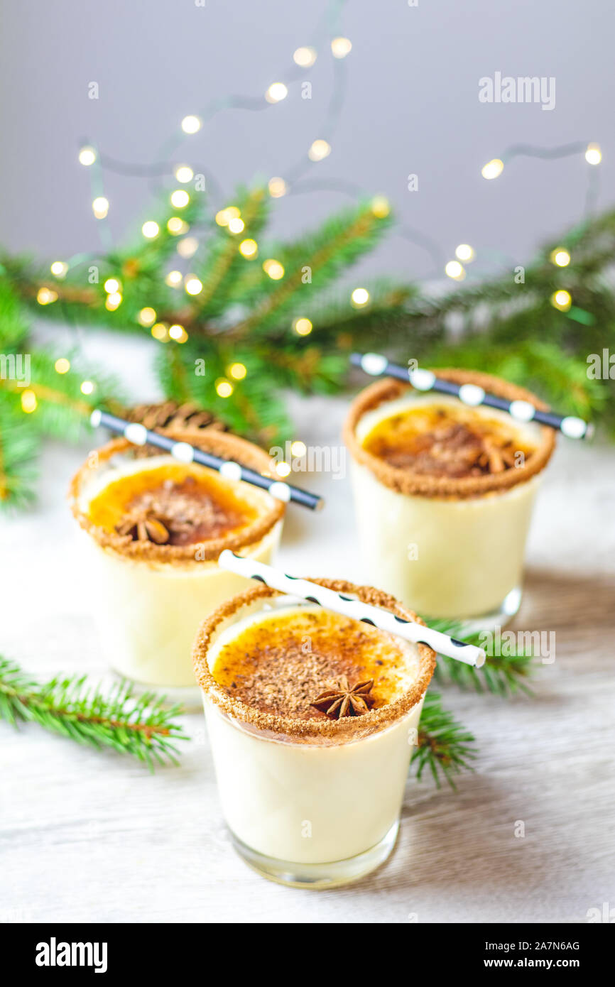 Eggnog with cinnamon and nutmeg for Christmas and winter holidays. Homemade  eggnog in glasses on wooden table surface, shallow depth of the field, cop  Stock Photo - Alamy