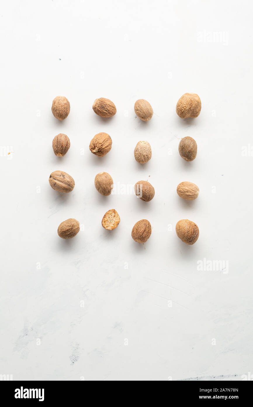 Aromatic nutmeg spice on white background Stock Photo Alamy