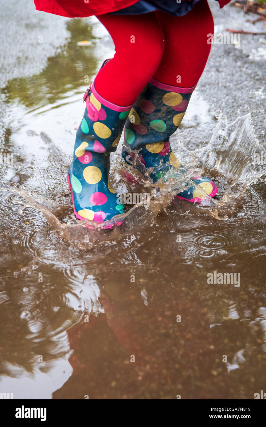 Splashing in muddy puddles Stock Photo