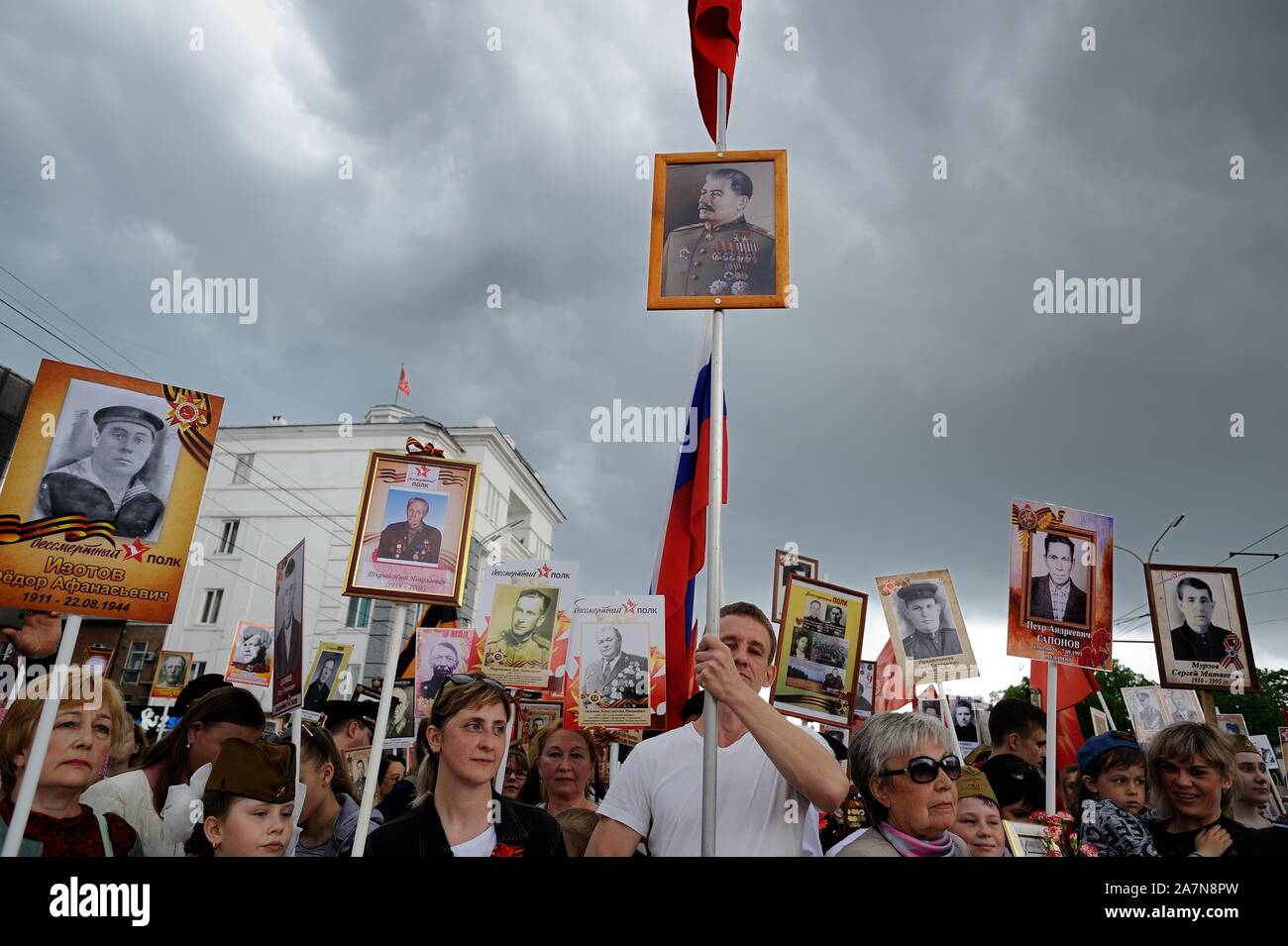 Orel, Russia, May 09, 2019: Victory Day, Immortal Regiment parade. Crowd with portraits of Stalin and their ancestors against cloudy gray sky backgrou Stock Photo